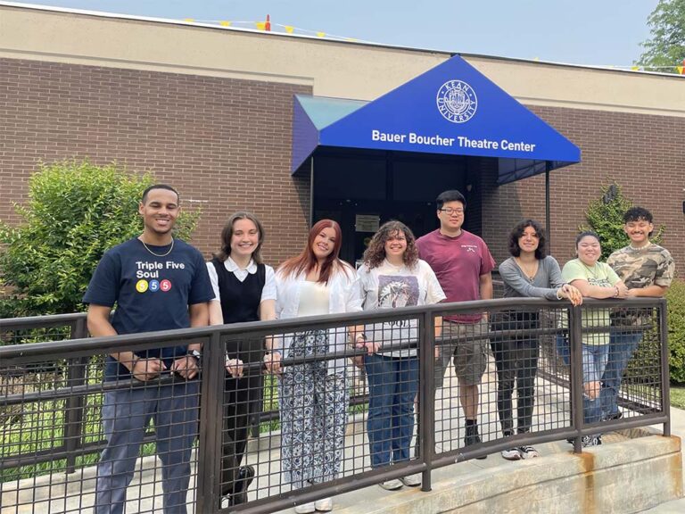 A group of interns standing in front of the Bauer Boucher Theatre Center